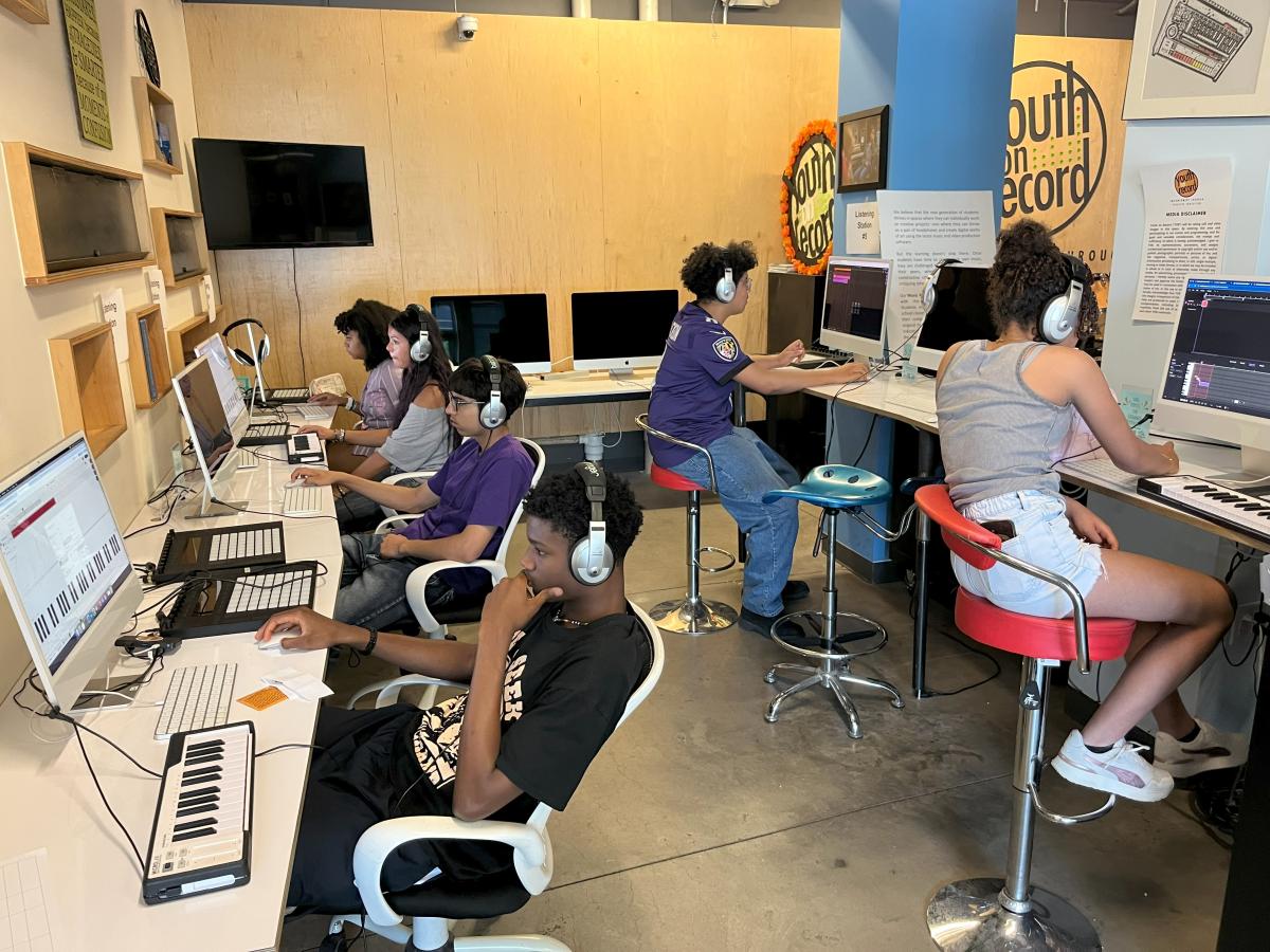 Youth edit podcast audio on computers