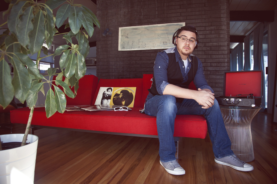 Andy Rok Guerrero sitting on a red couch