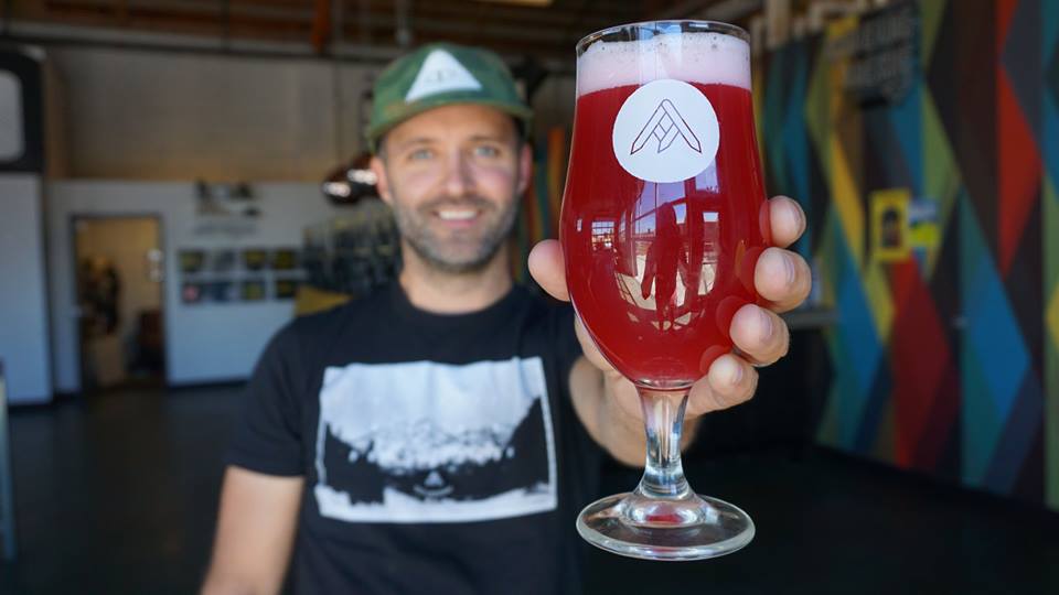 Jason zumBrunnen of Ratio Beerworks, holding a glass of beer.