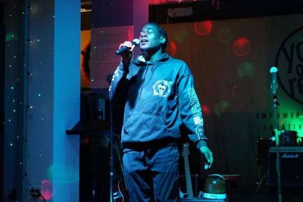 Young artist sings into microphone