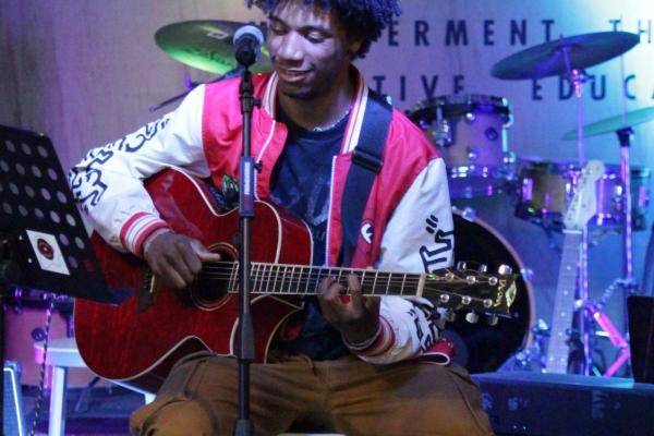 Gabe plays guitar at Youth on Record