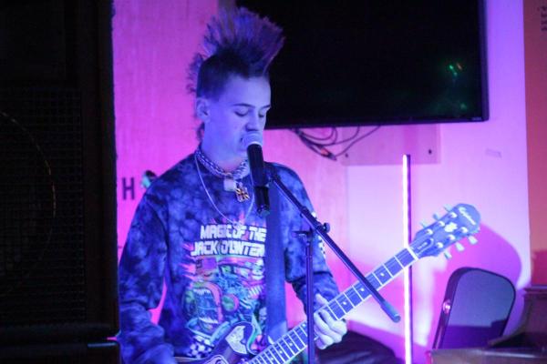 tiago plays guitar at open mic