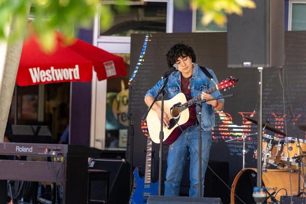 Carlitos Villalpando plays guitar on stage at YOR Fest