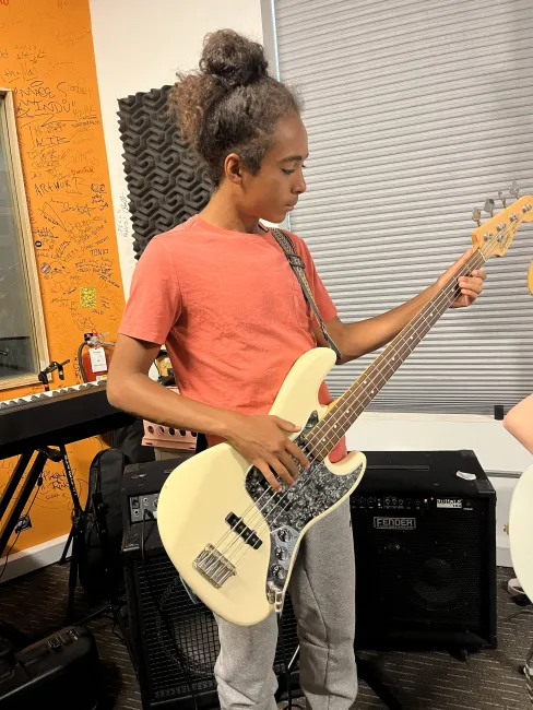 Student plays guitar