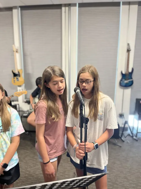 campers sing into mic