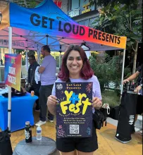 Sydney working at 16 LIVE and holding a YOR Fest poster