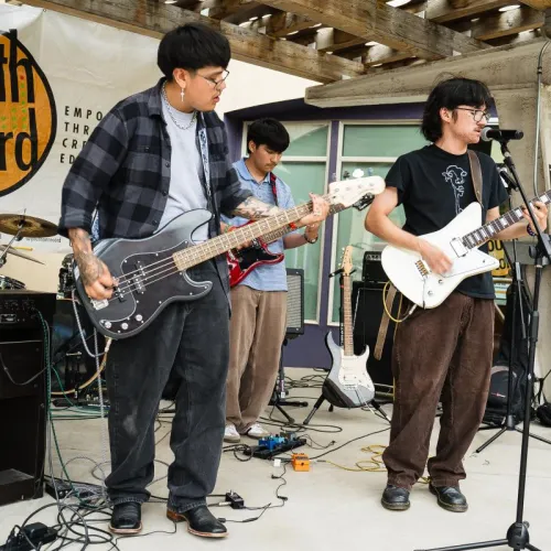 A group of young artists perform together on stage